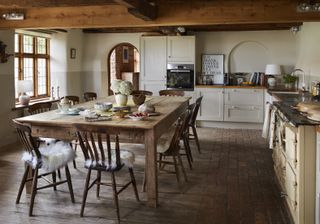 wooden dining area in kitchen in brick-and-flint house