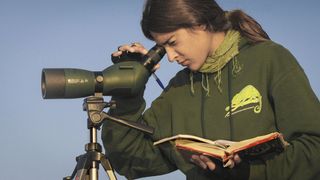 woman using spotting scope on a tripod