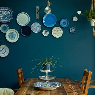blue kitchen with dining table and plant