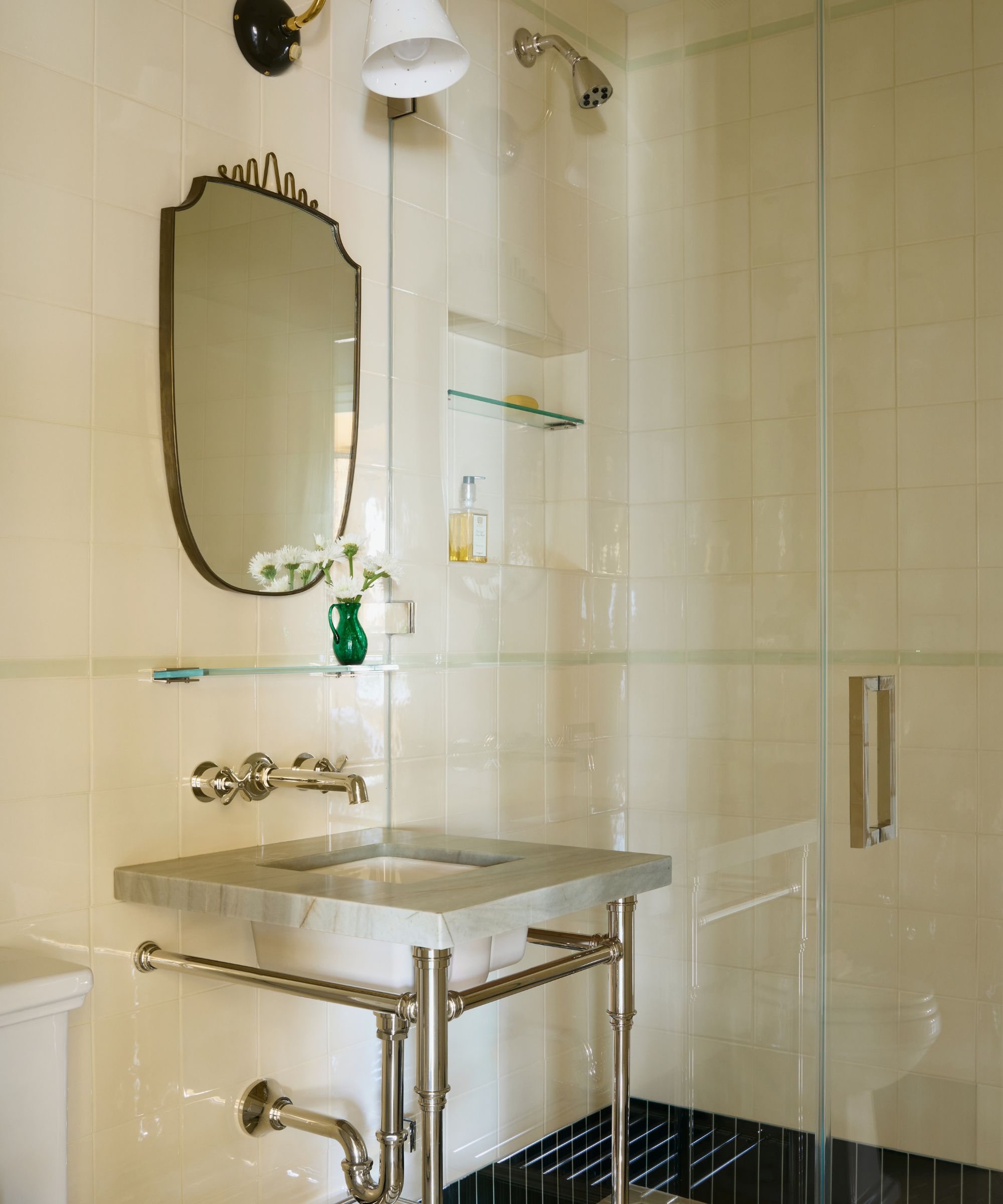 a warm mint green and cream ensuite bathroom with walk in shower and green marble vanity
