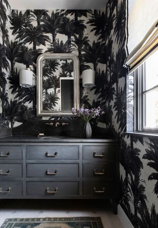 Black bathroom with palm print wallpaper