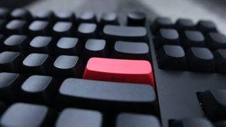 The Keychron Q3 Max gaming keyboard set-up on a desk with the RGB lighting enabled.