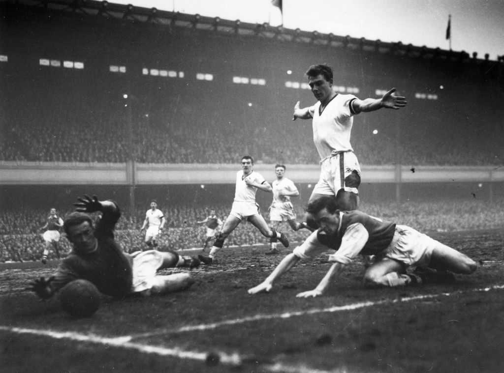 Manchester United goalkeeper, Gregg (left), makes a save. He is watched by United right-back Foulkes (centre) and Duncan Edwards (arms outstretched), as Manchester United play Arsenal at Highbury This was United's last game before their fateful journey to Belgrade to face Red Star in a European Cup Quarter Final, which resulted in the Munich plane crash