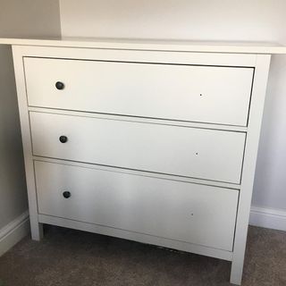 drawers with cream colour and white wall