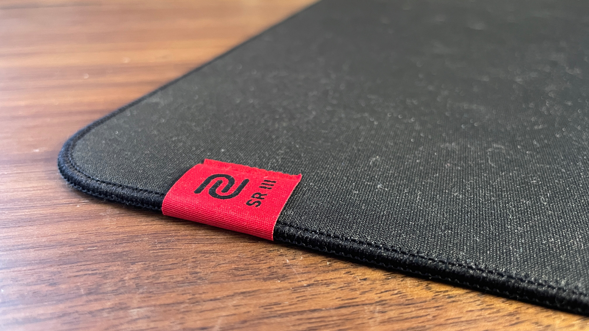A Zowie H-SR III mouse pad on a desk.