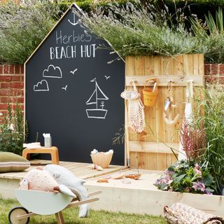 garden with kids play area with chalkboard sign