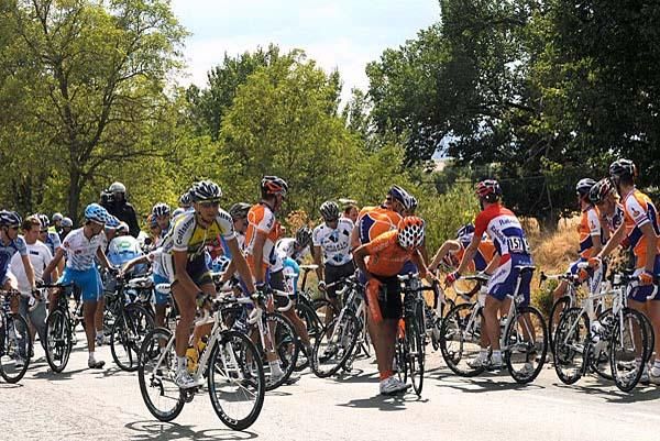 Riders try to sort out their bikes and get going again after a crash.