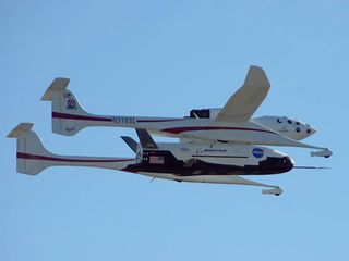 The X-37 space plane seen attached to the WhiteKnight carrier aircraft during test flight.