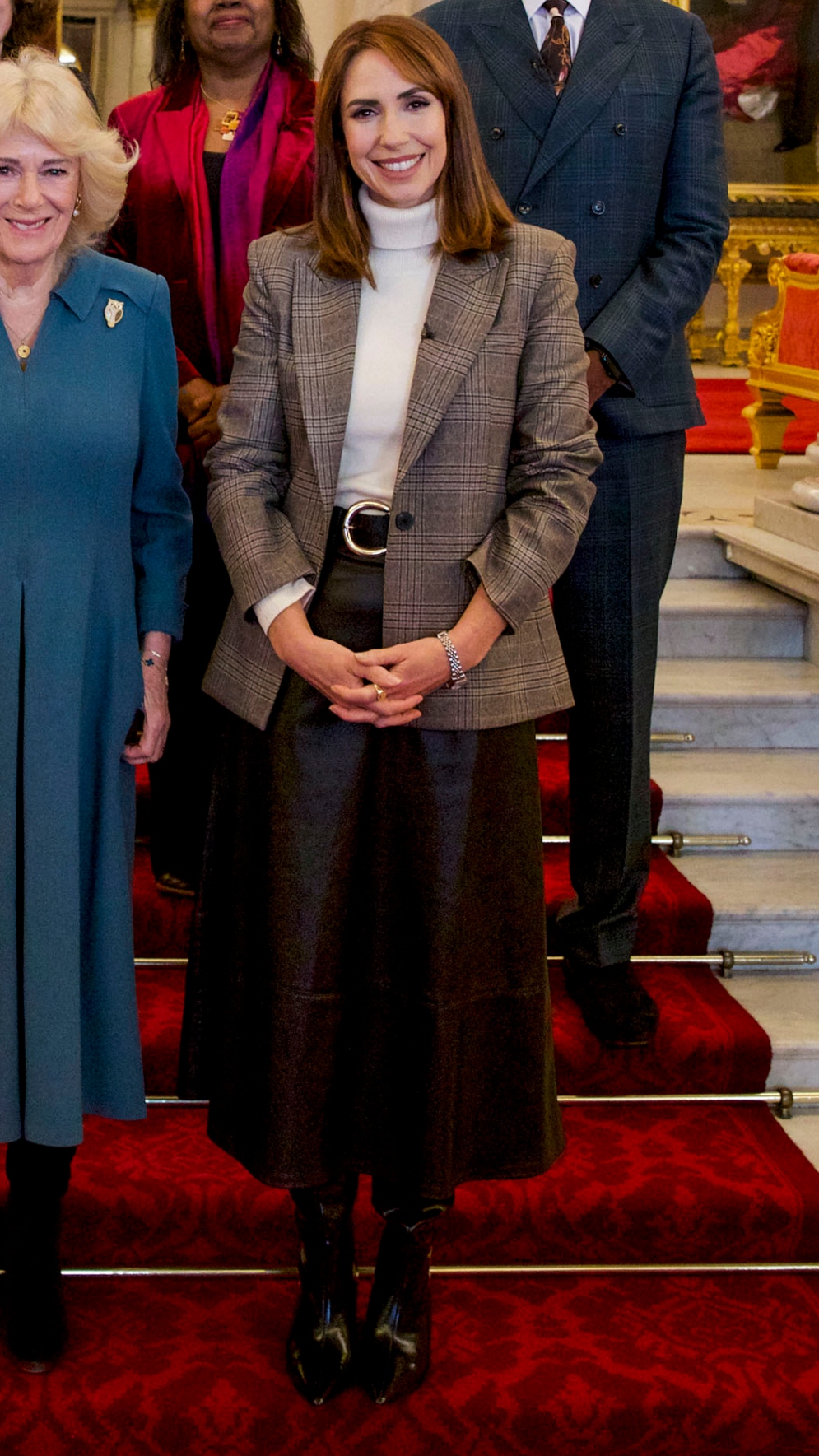 Alex Jones stands on the steps of Buckingham Palace