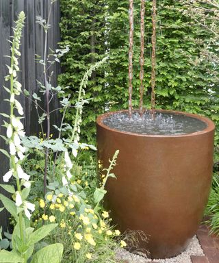 collecting rainwater using rain chains and a large water feature
