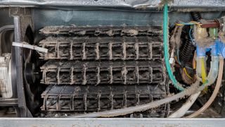 Dirty condenser coils on fridge