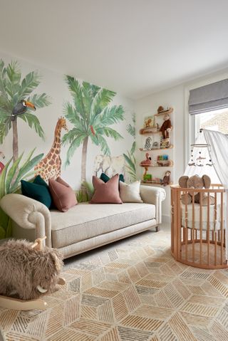 A small nursery with a nature-themed wallpaper