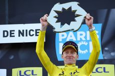 Man holds up a prize shaped like a sun