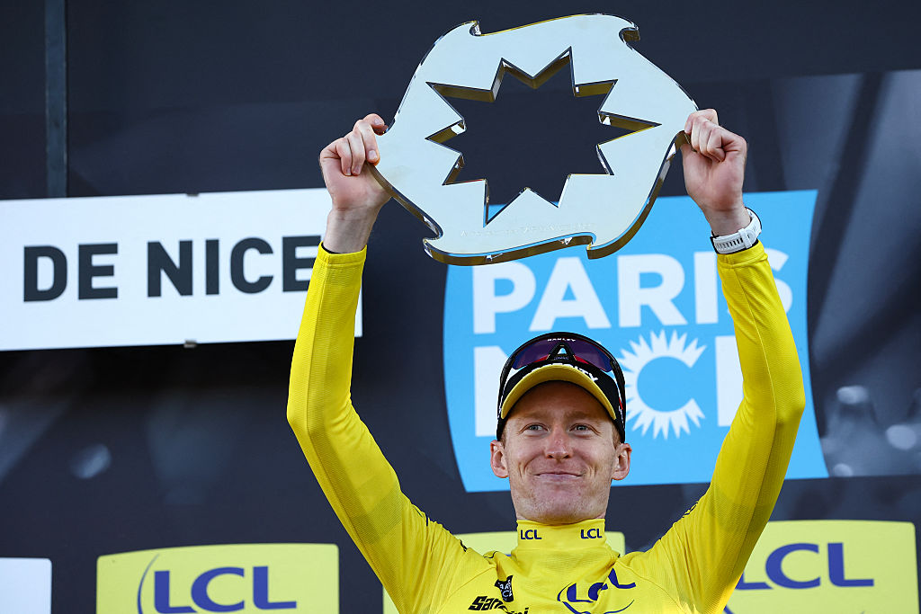Man holds up a prize shaped like a sun