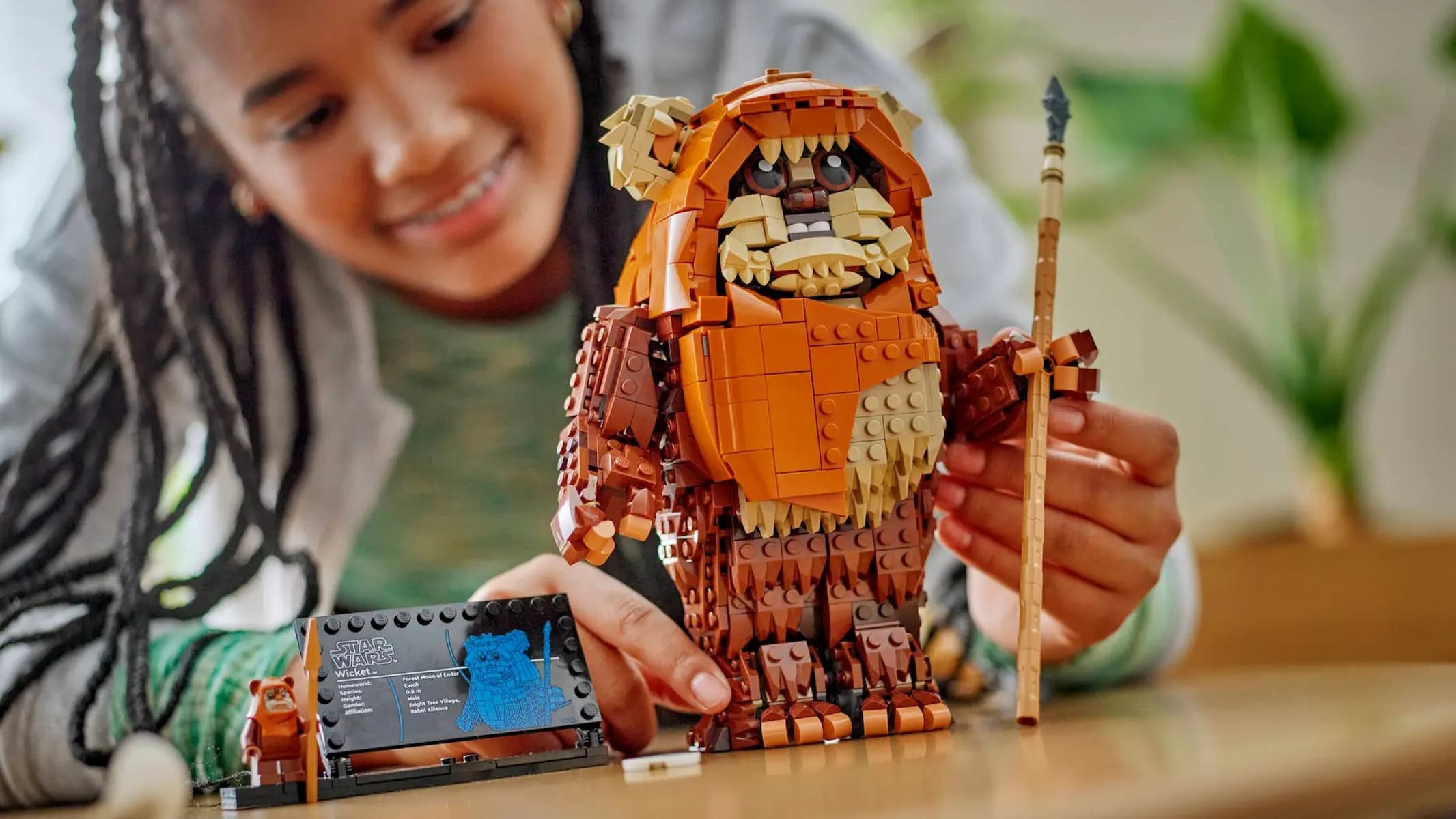 Lego Star Wars Wicket the Ewok being played with by a girl.