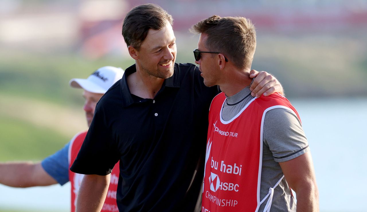 Perez celebrates with his caddie after his win