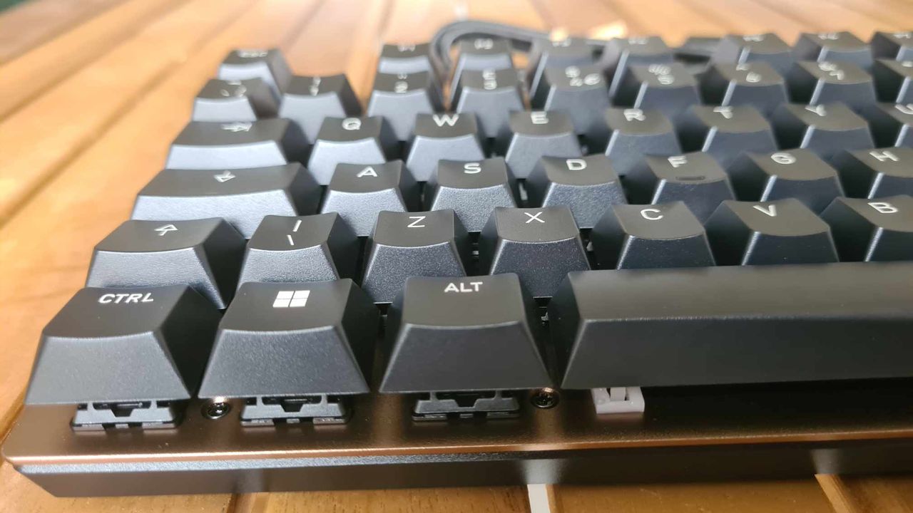 Cherry KC 200 MX gaming keyboard on a wooden table.