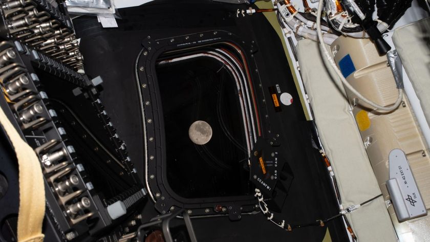 A view of the moon through a window of a space capsule.