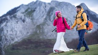 Bridal couple hiking with backpacks, Urkiola mountain, Spain