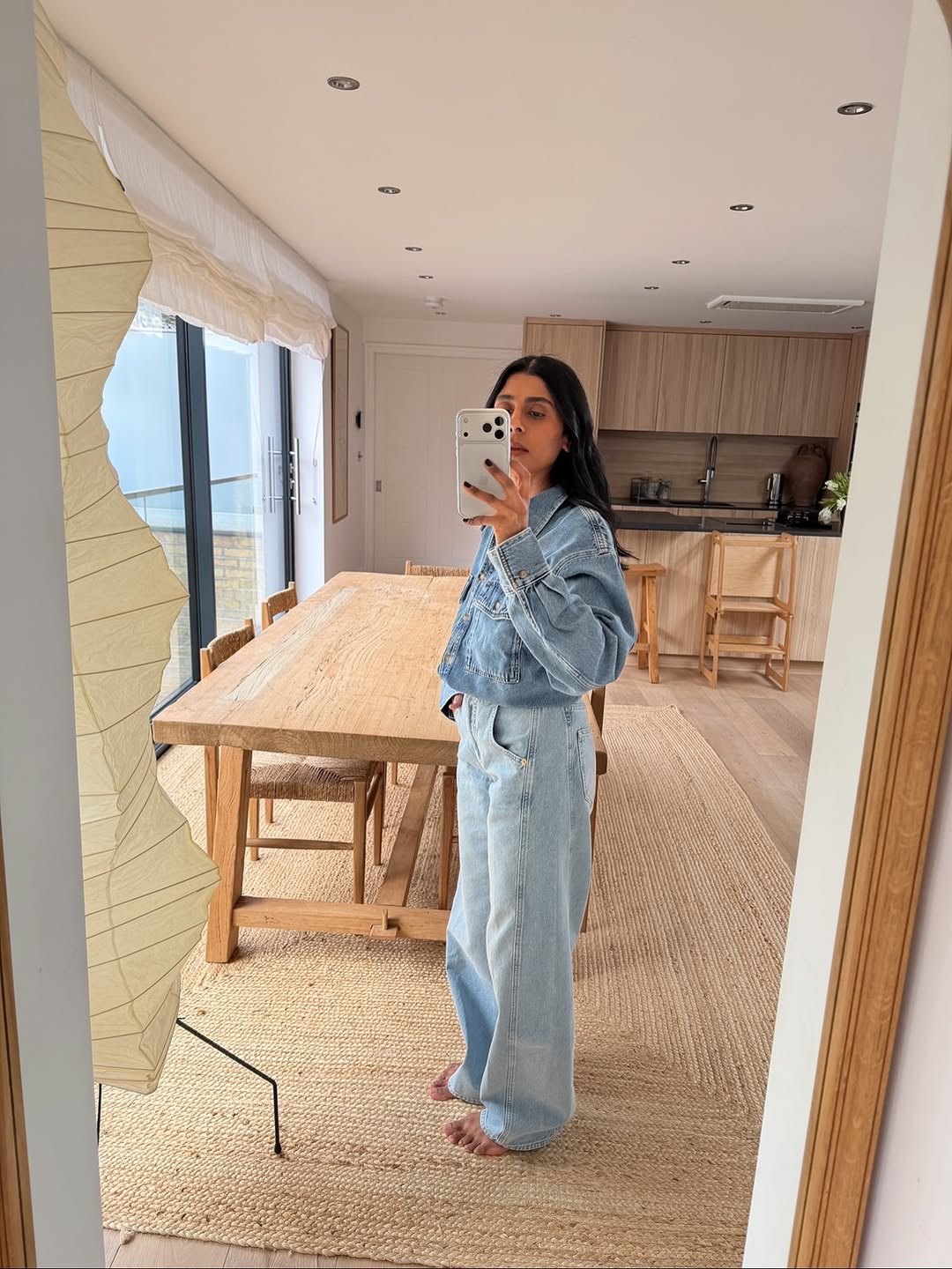 Monikh in light wash double denim outfit