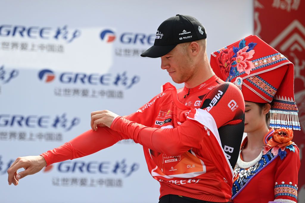 QINZHOU CHINA OCTOBER 13 Jonathan Milan of Italy and Team Bahrain Victorious celebrates at podium as Red Leader Jersey winner during the 4th GreeTour of Guangxi 2023 Stage 2 a 1496km stage from Beihai to Qinzhou UCIWT on October 13 2023 in Qinzhou China Photo by Tim de WaeleGetty Images