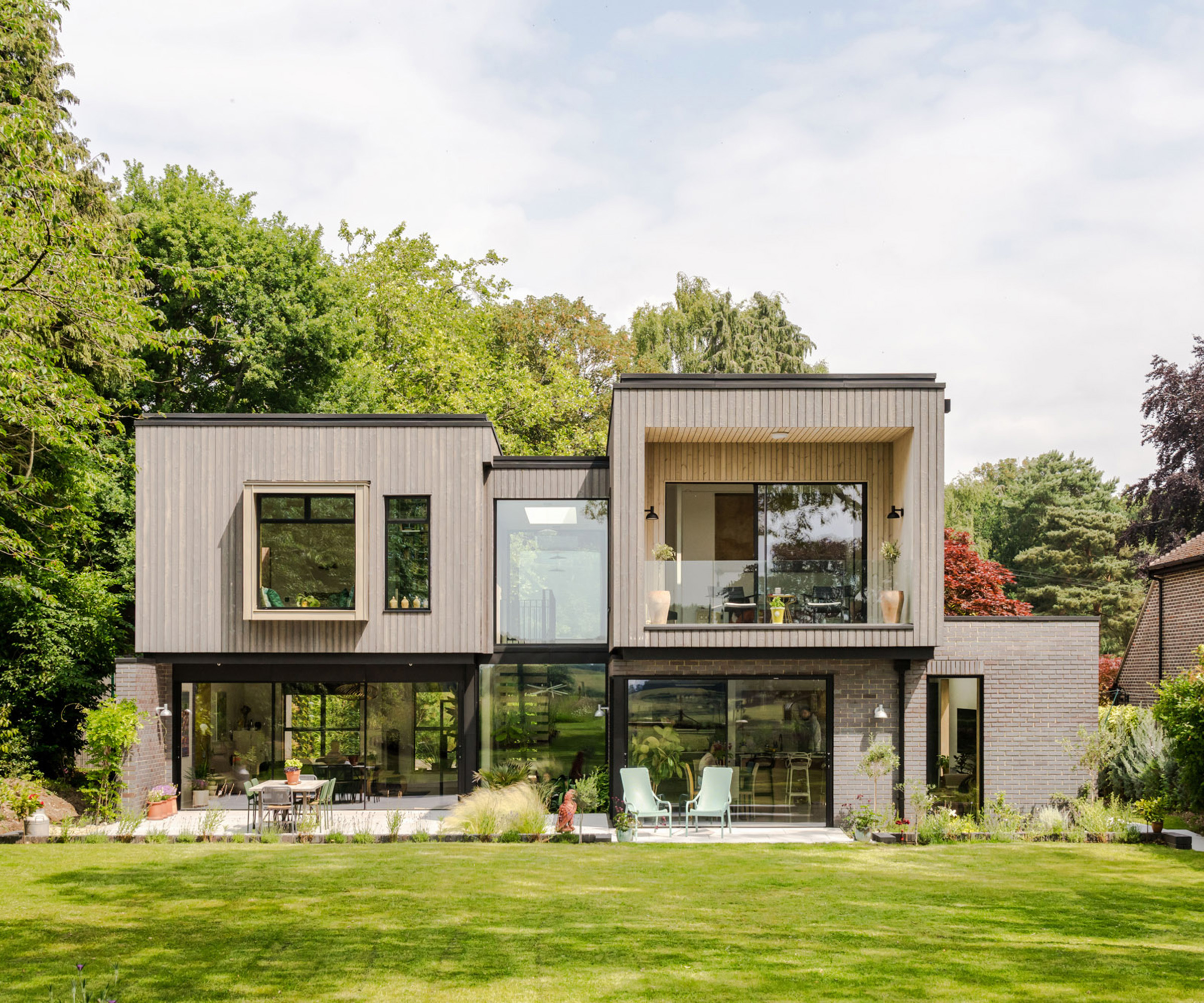 Rear exterior of a contemporary self build home with bold geometric forms