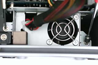 Loosen the two screws pointed out to free the motherboard tray from the case