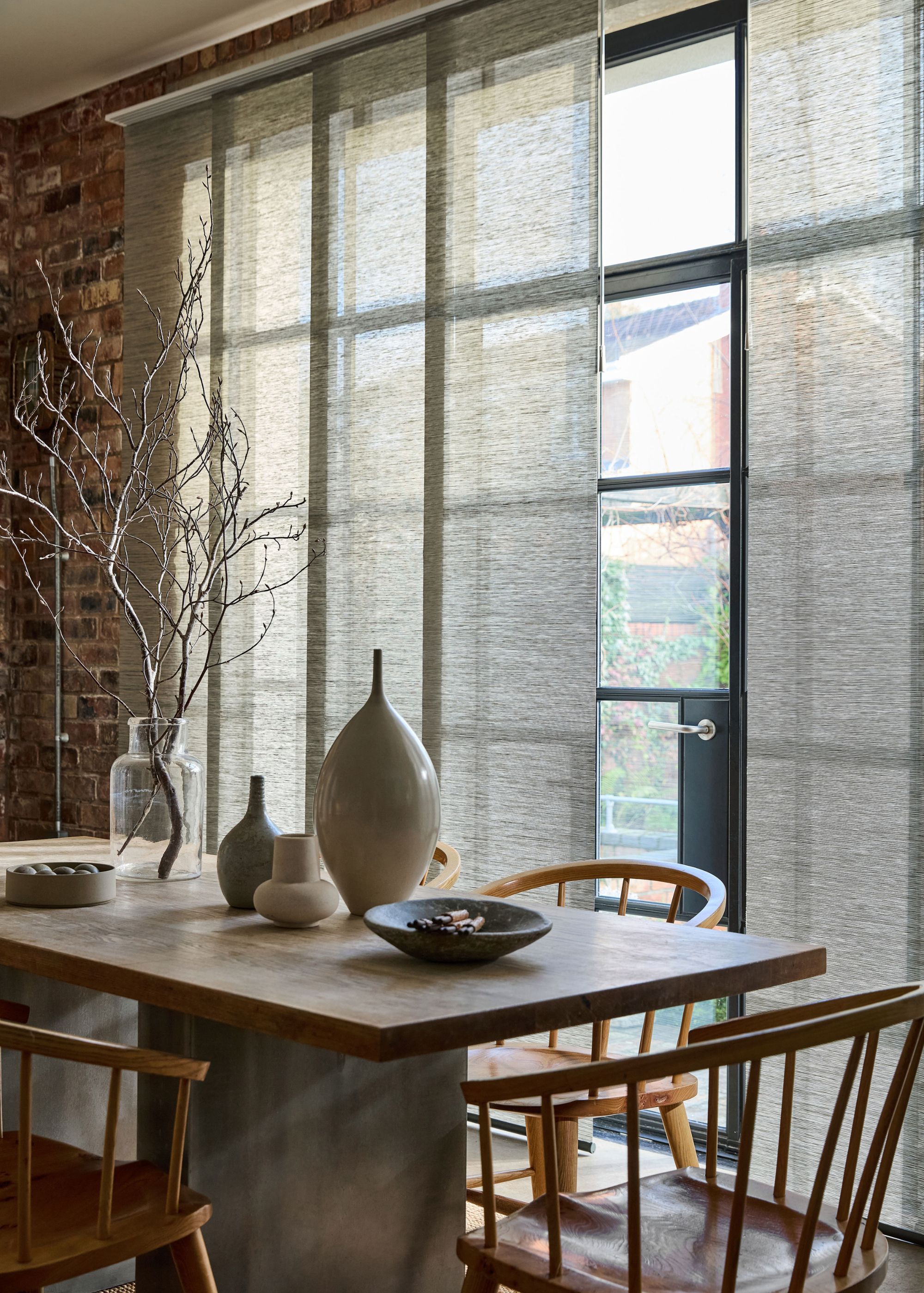 dining room with large glass doors with panel blinds