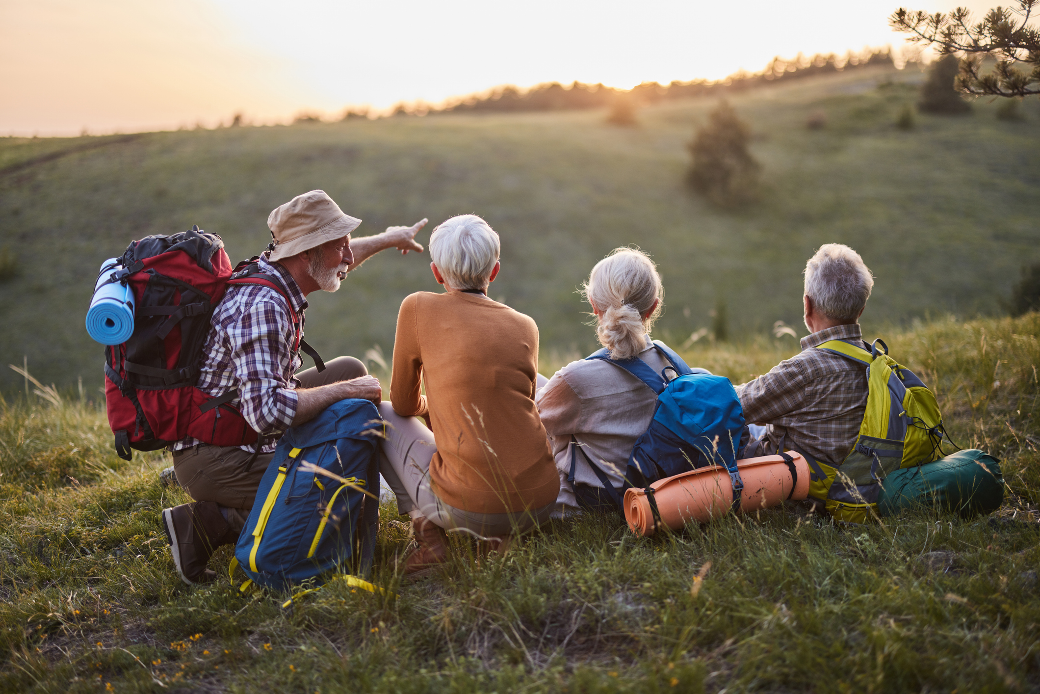four people taking a break from hiking