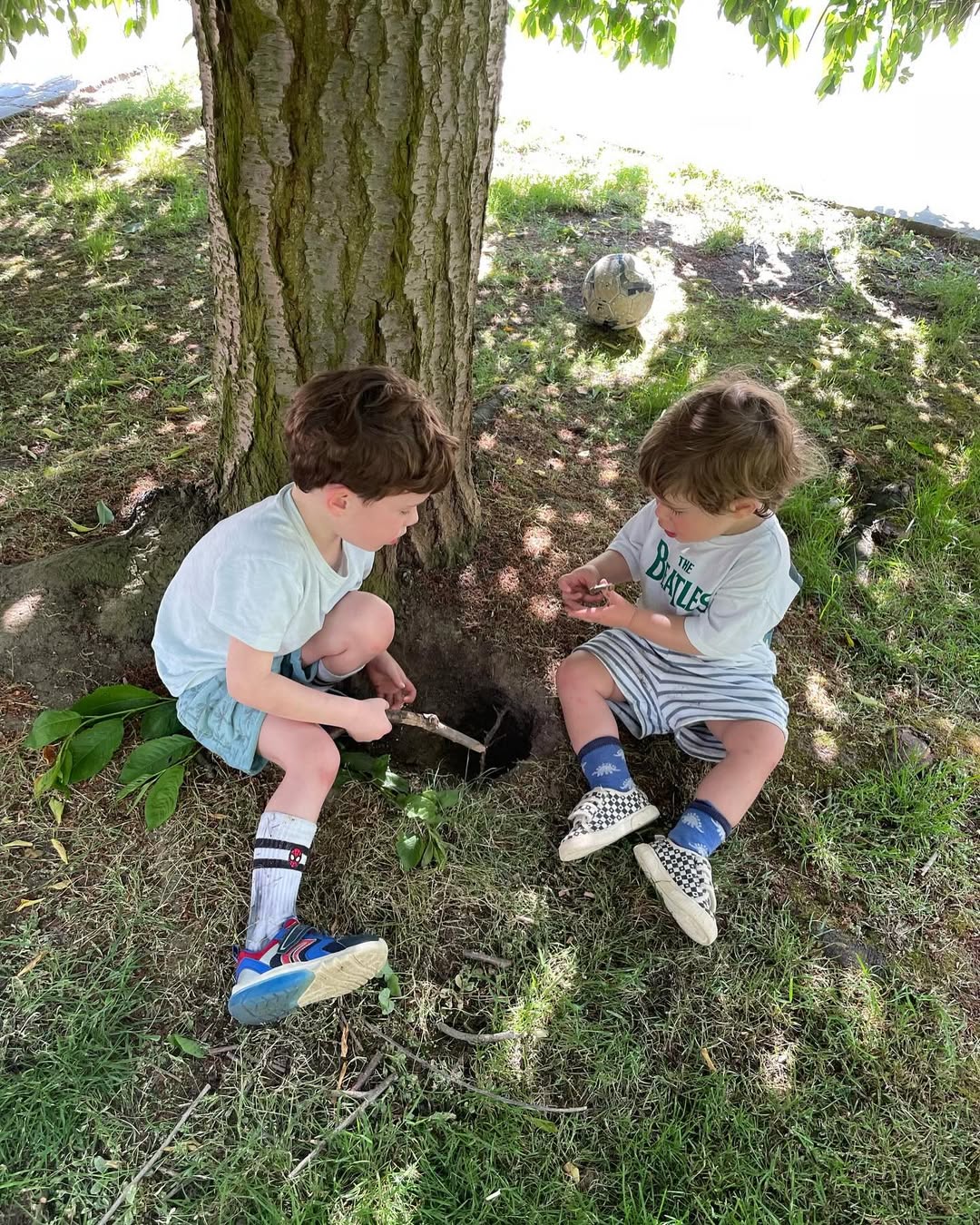 Ernest and AUgust Brooksbank playing in grass