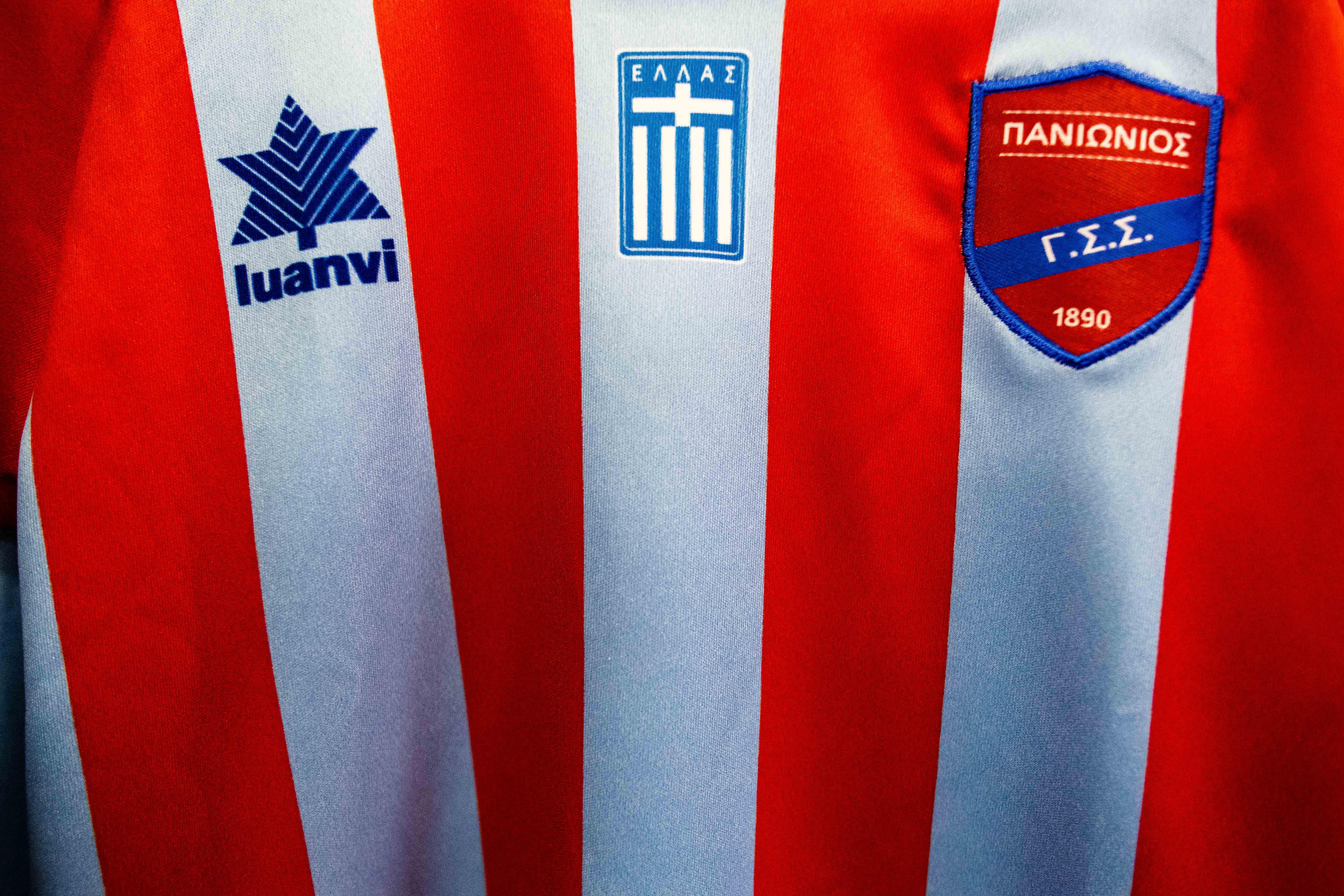 A close-up of a red and white striped Panionios home shirt