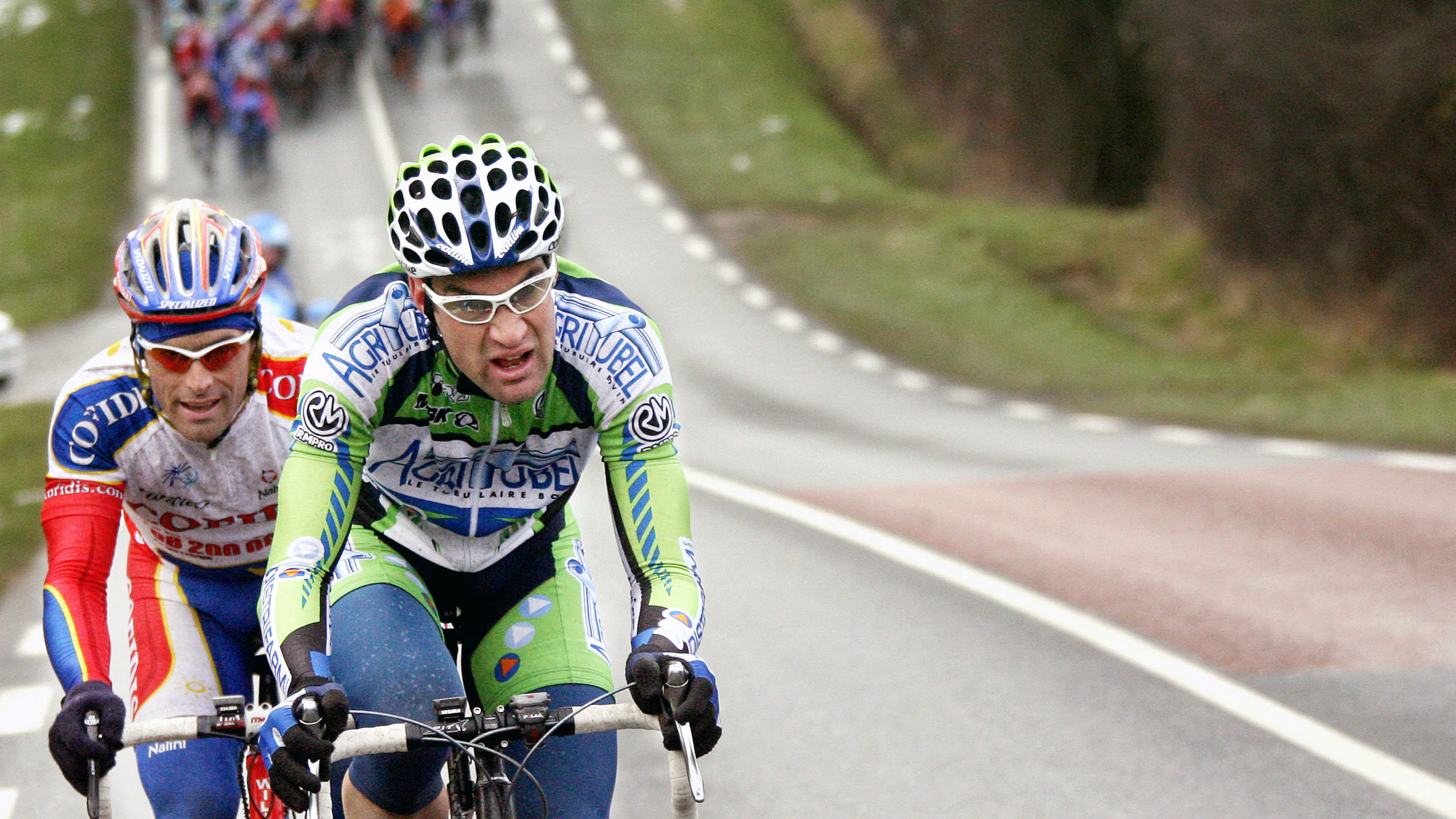 French rider Christophe Laurent (L/Agritubel) and his compatriot Stephane Auge (Cofidis) ride in the leading pack during the first stage of the 64 edition of the Paris/Nice cycling race between Villemandeur and Saint Amand-Montrond 6 March 2006. 