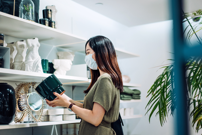 Woman looks around store as the shops which can stay open until 10pm are announced