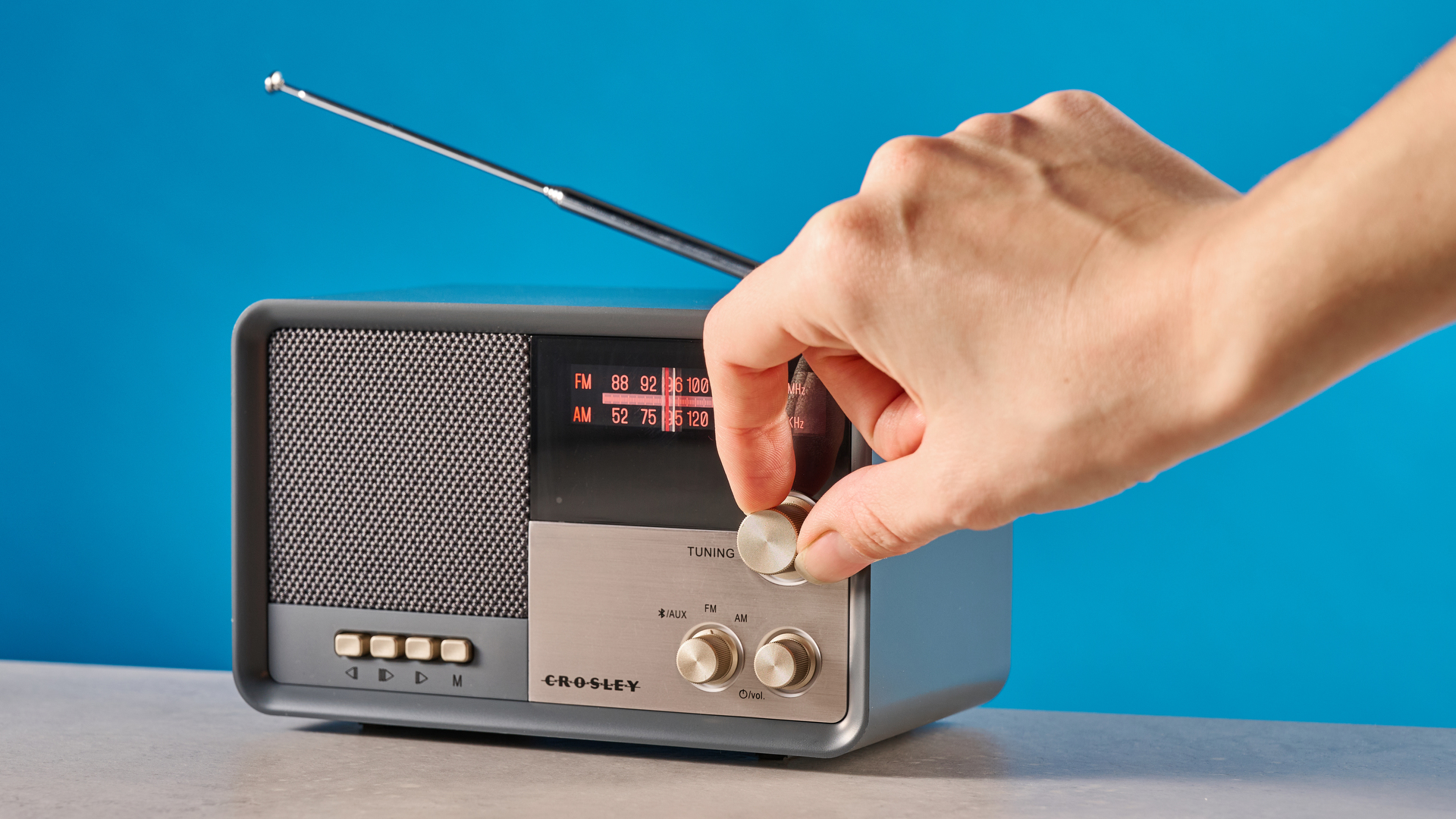 Crosley Tribute Radio in gray color photographed on a blue background