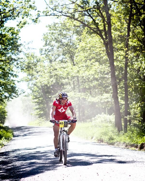 Rebecca Rusch (Specialized) on a dusty road section.