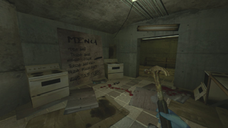The player stands in a cluttered factory kitchen wearing blue gloves and holding a hammer 