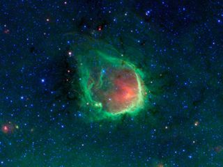 This glowing emerald nebula seen by NASA's Spitzer Space Telescope is reminiscent of the glowing ring wielded by the superhero Green Lantern.