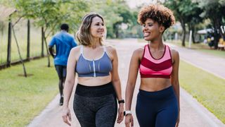 Woman laughing and walking together after a run