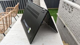 A black Acer Swift Edge 16 laptop sitting on a garden table