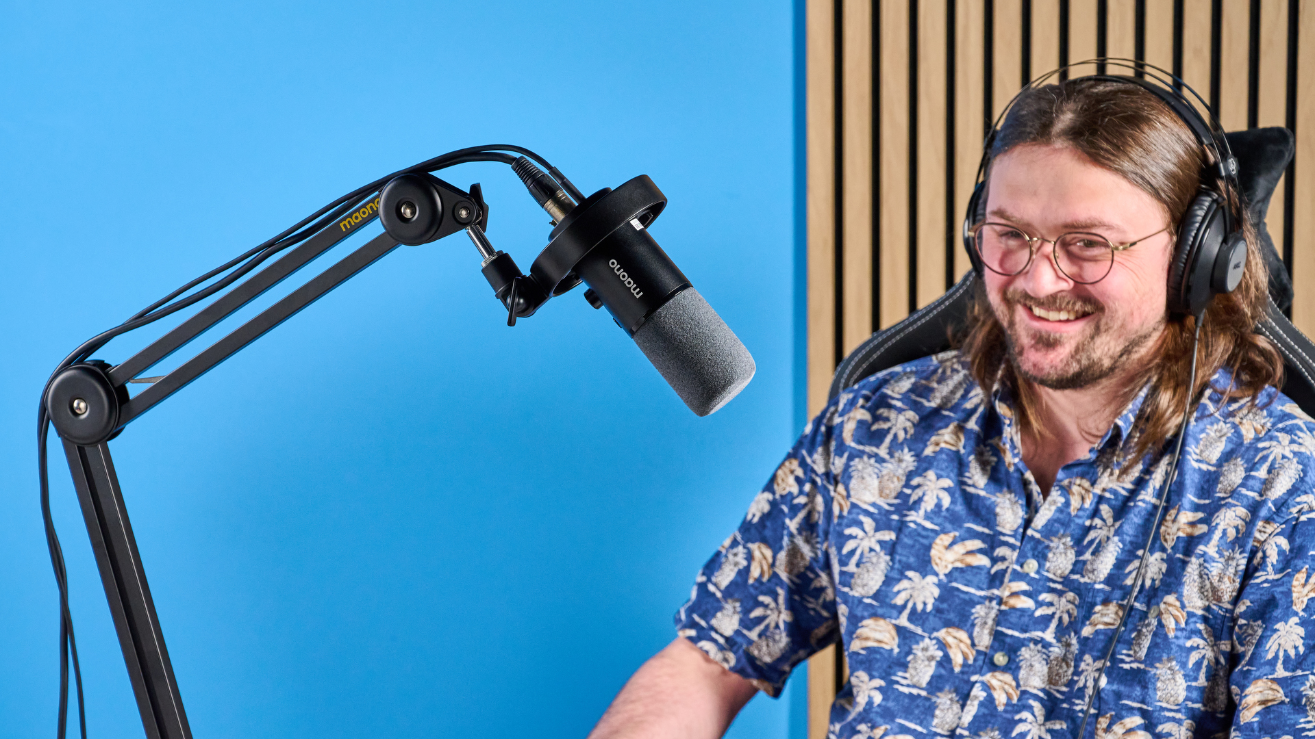 the maono pd1300x microphone for podcasting with an xlr and usbc connection and a boom arm in the photograph but also available with a desktop stand, one button dial on the mic and a muting button