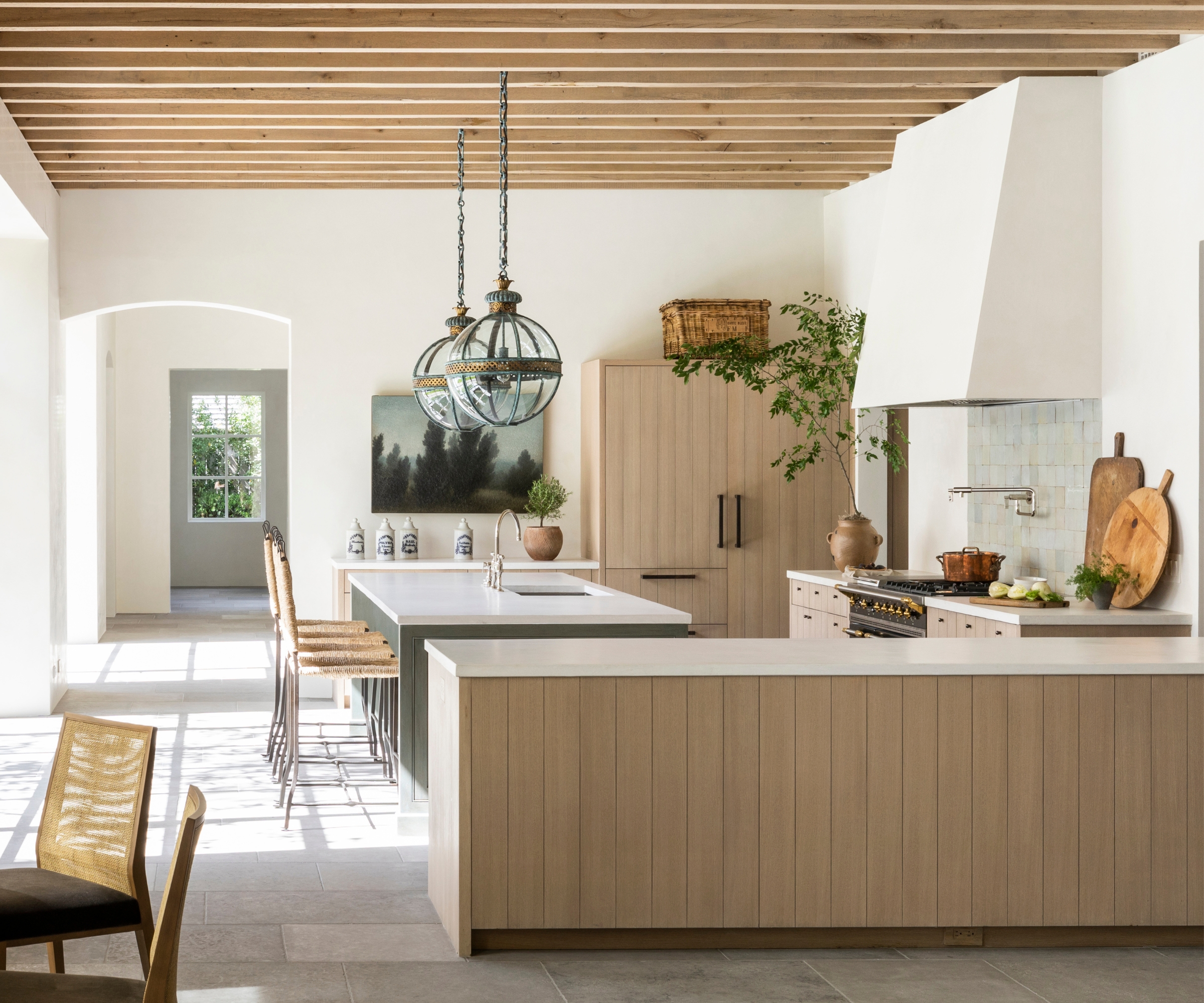 An open plan kitchen with a peninsula to divide the cooking and lounging spaces