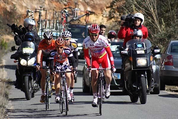 The four-man break rides off the front