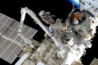 Russian cosmonaut on the space station with blue Earth in the corner