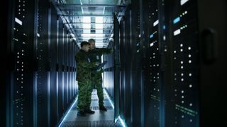 Military personnel examine a server