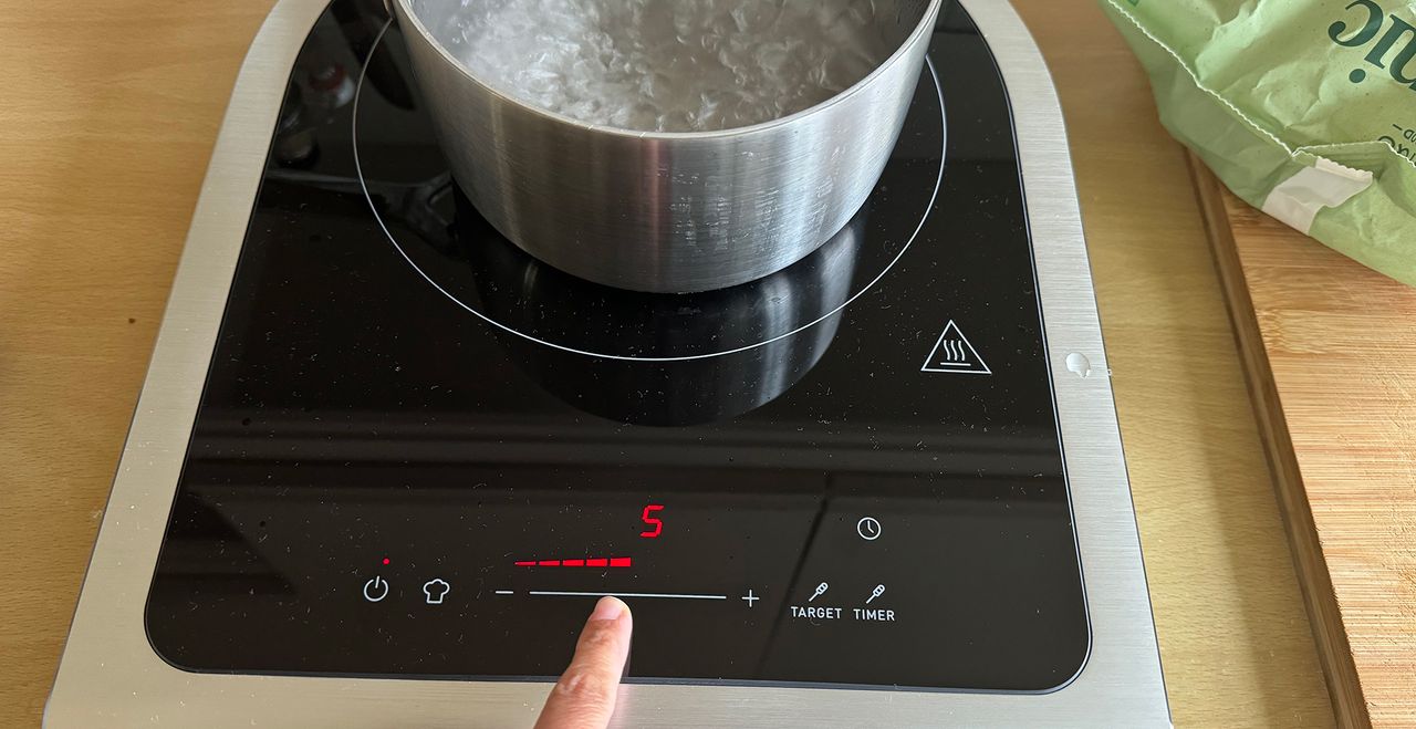 Rosie testing the control panels on the new Smeg portable induction hob