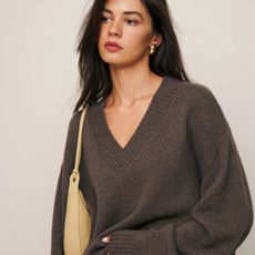 Woman wears taupe v-neck cashmere jumper