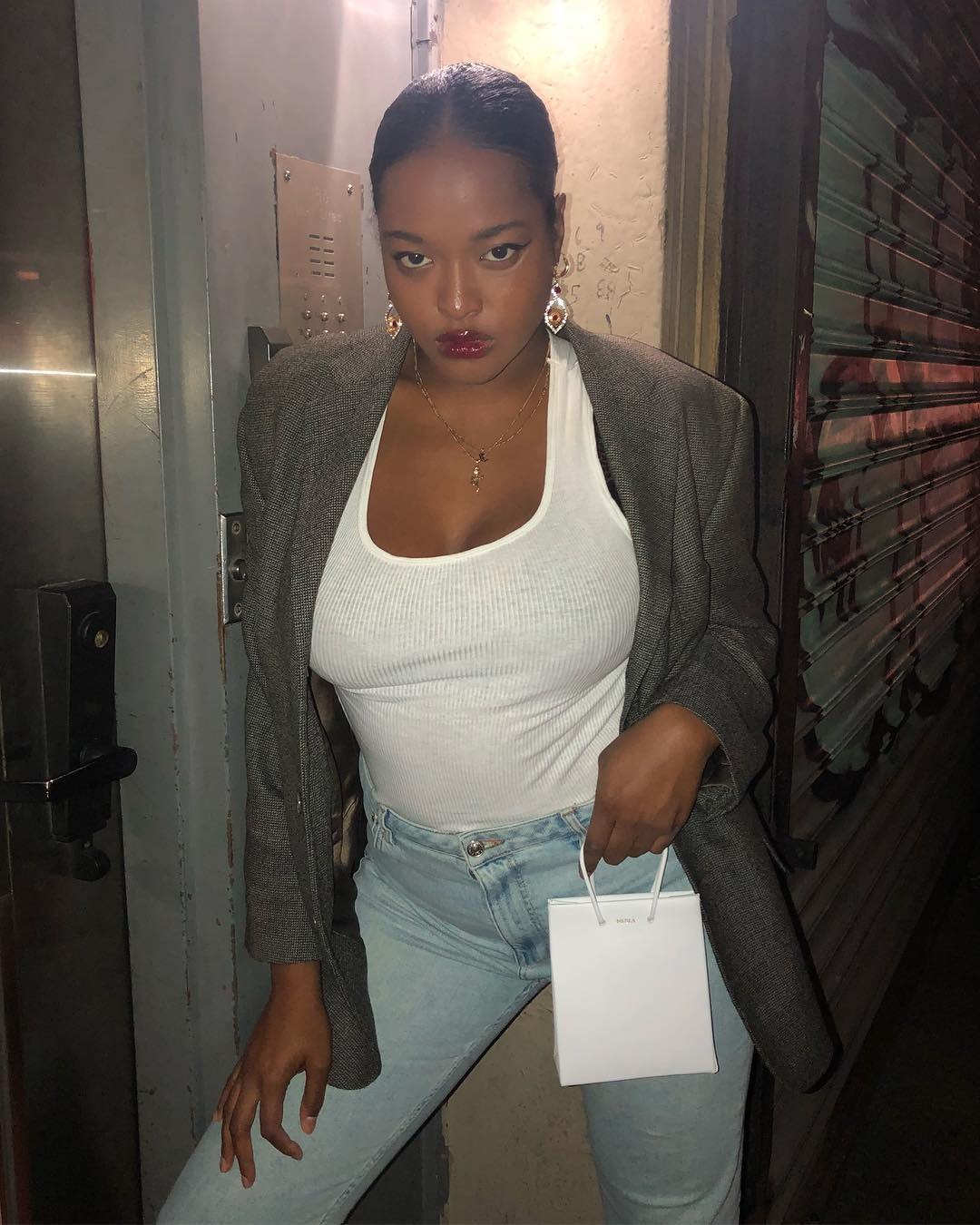 Imani Randolph wears a white tank top with jeans.