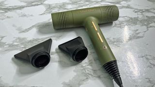 The mdlondon Blow hair dryer is shown next to the two concentrator nozzles