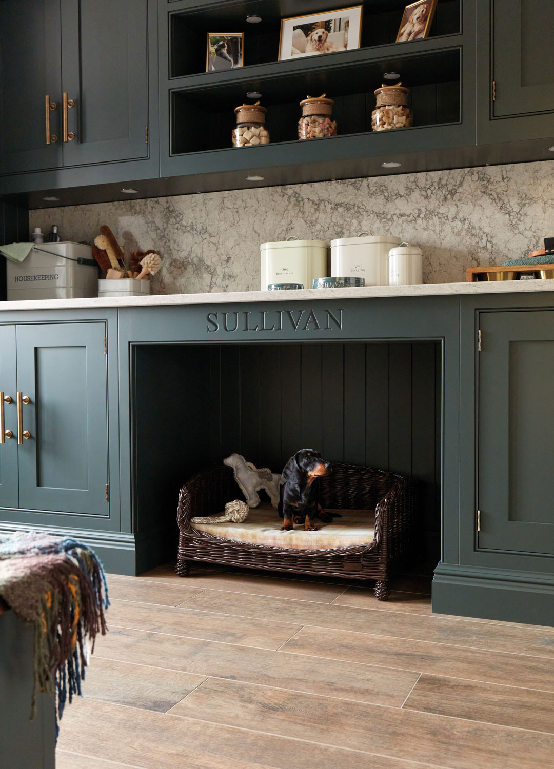bespoke kitchen with built-in dog bed with carved pet name and pet storage
