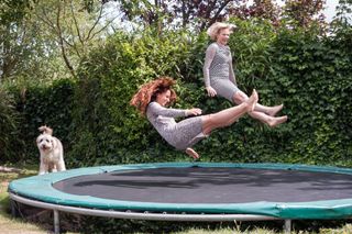 two women bouncing on a trampoline - what to look out for when buying a trampoline